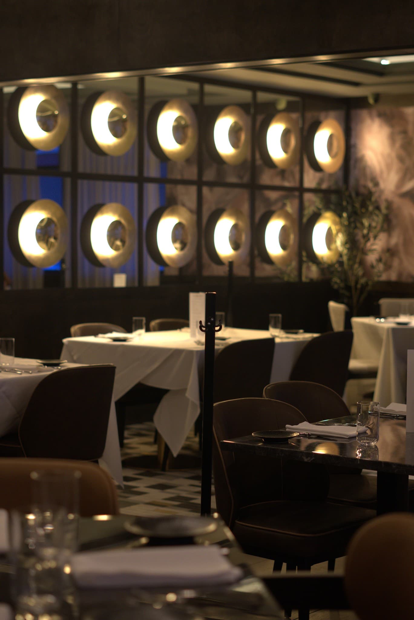 Dining room at Fuego Vivo with warm circular wall sconces